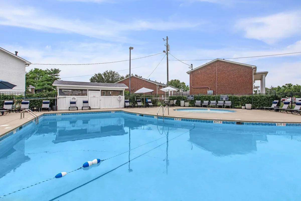 A relaxing community pool area with swimming pool, lounge chairs, and a poolside cabana, all bathed in sunset light. The scene suggests both relaxation and opportunities for networking or unwinding outdoors.